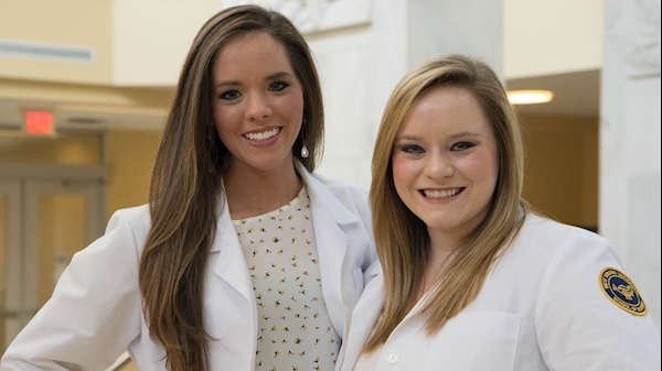 Lauren Linton poses with her sister Claire Linton (right) in front of the Pylons at Health Sciences Morgantown