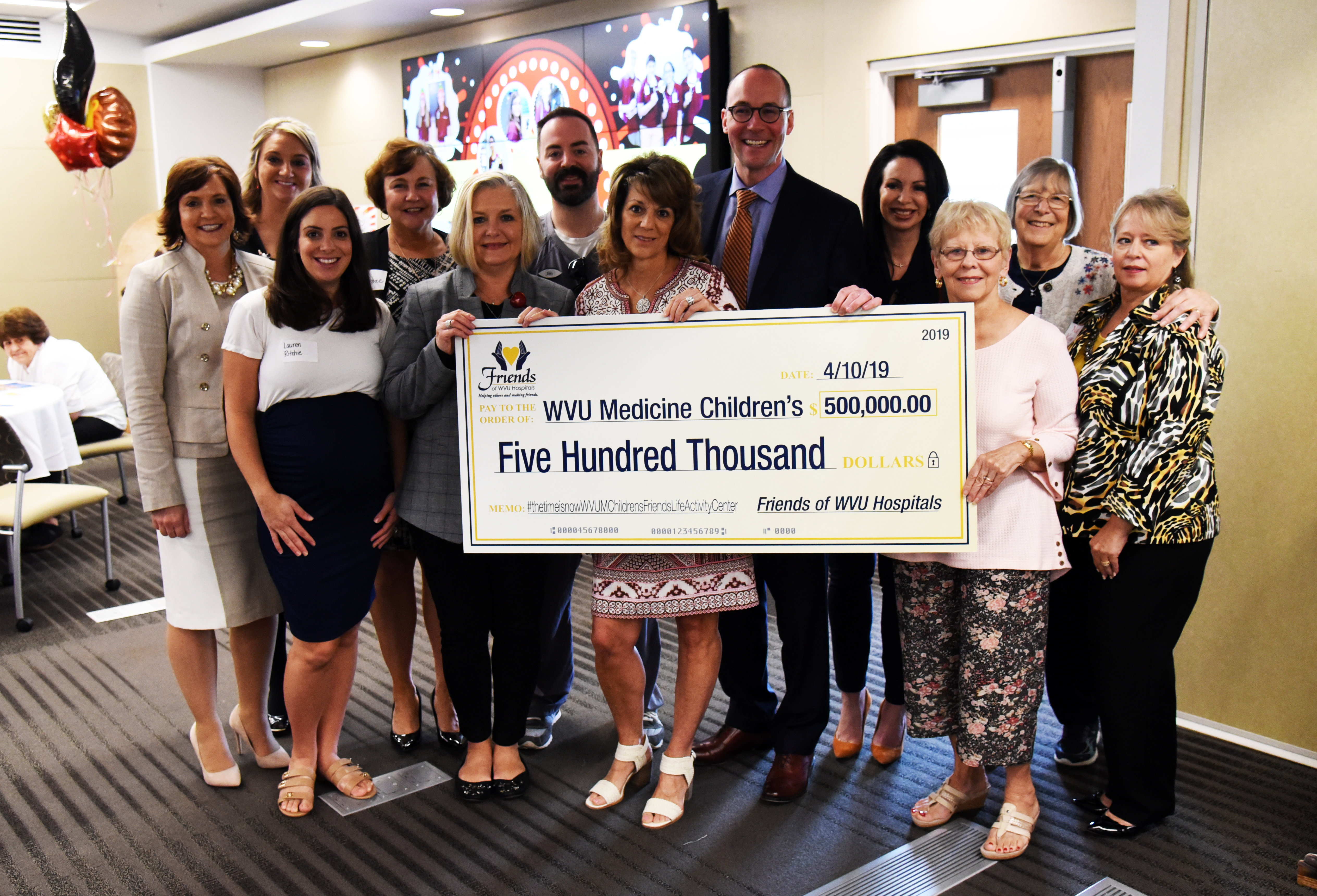 The Friends of WVU Hospitals Board of Directors presents a check for $500,000 to the WVU Medicine Children's "Grow Children's" Capital Campaign.