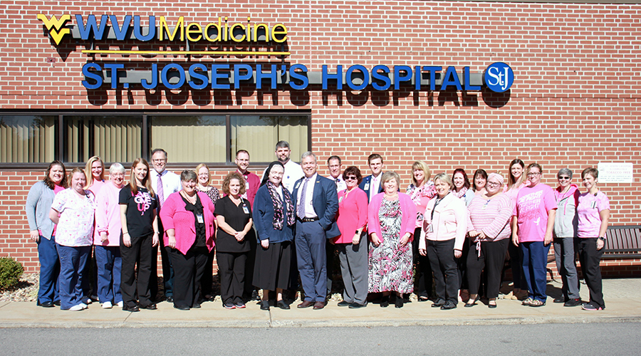 St. Joseph's Hospital staff gathered outside the main entrance for a group photograph to show their support of Breast Cancer Awareness Month