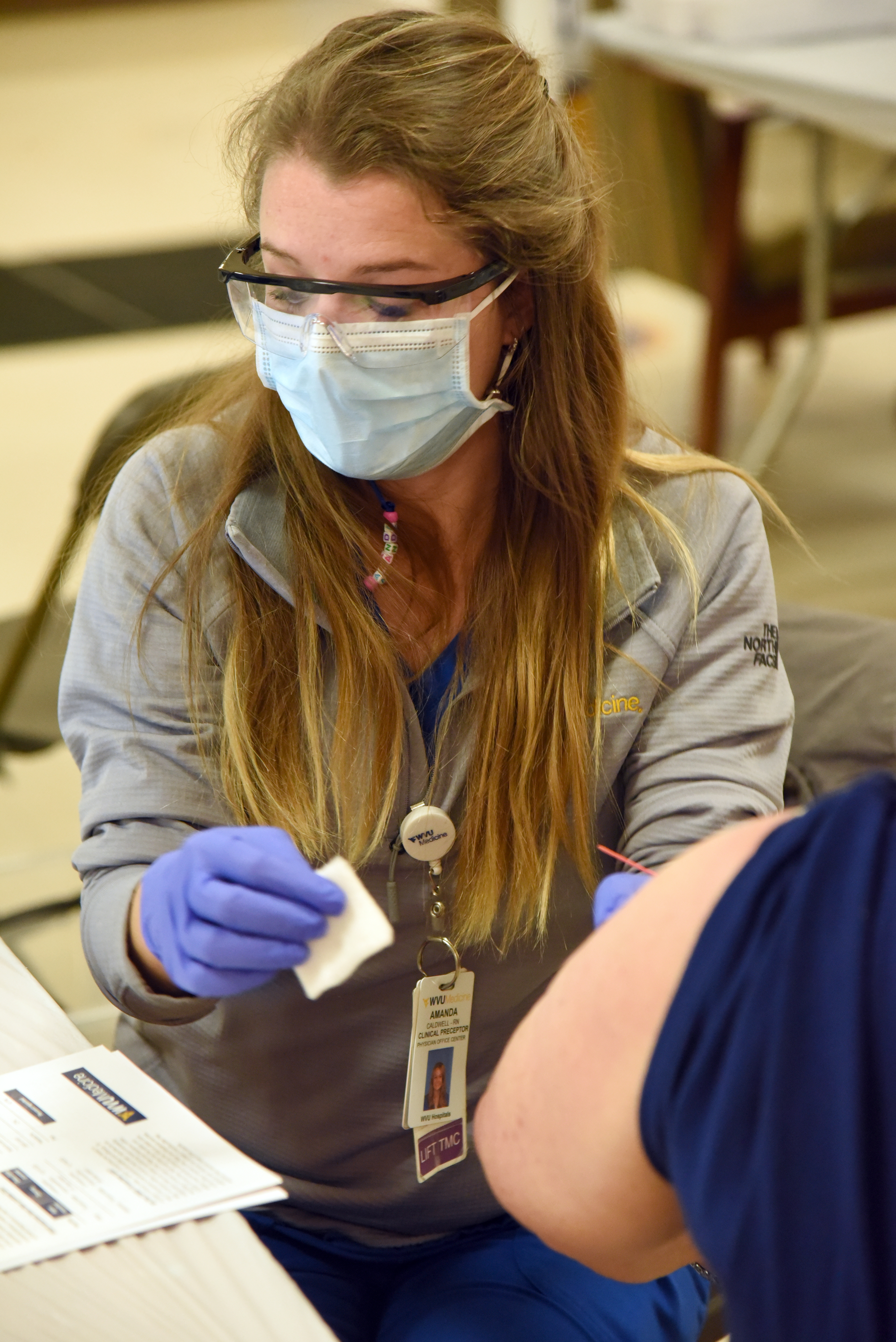 Nurse prepares to give shot at WVU Medicine vaccine clinic