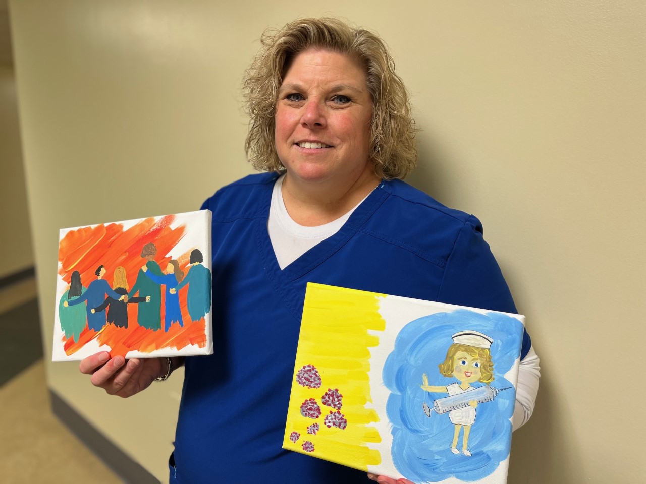 Joanne Watson, Director of BSN Programs, shows her two paintings.. 