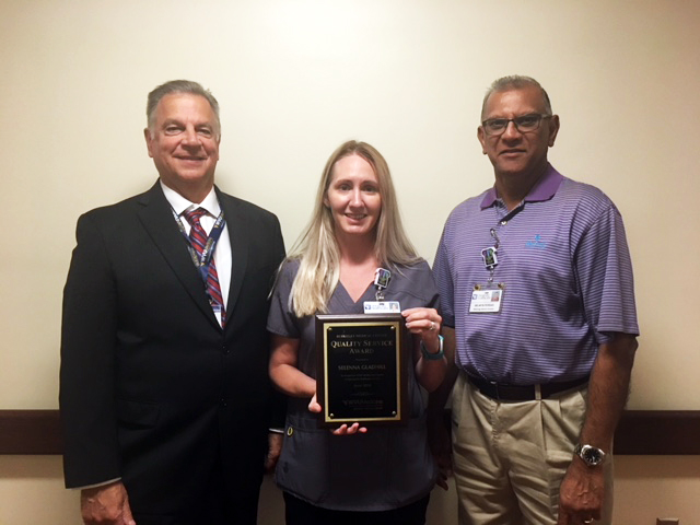 WVU Medicine Berkeley Medical Center’s June Quality Service Award winner is pictured receiving her award. Left to right: President/CEO Anthony P. Zelenka, QSA Winner Selenna Gladhill, and Radiology Director Selwyn Persad.