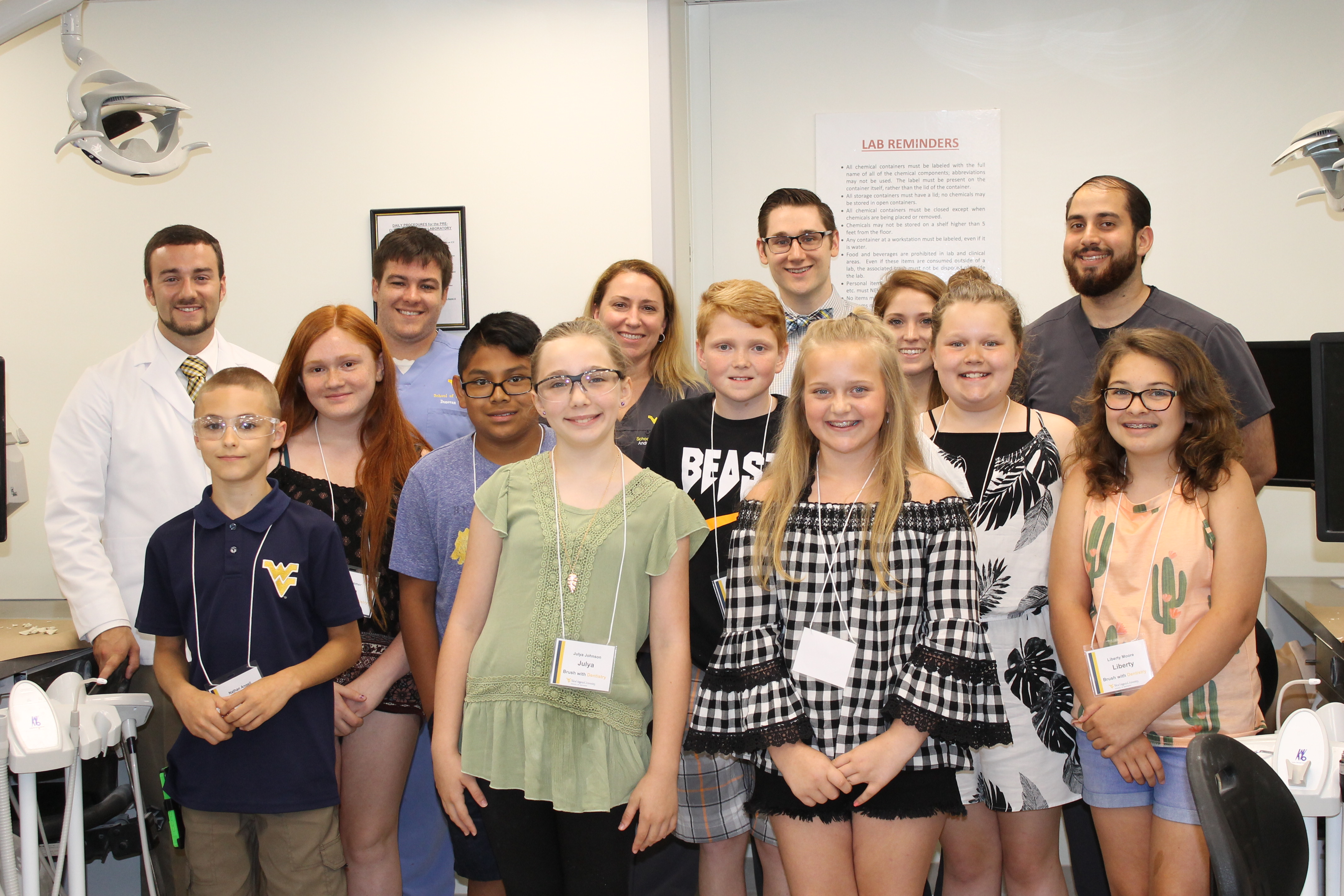 WVU School of Dentistry students pose with middle school Brush with Dentistry participants after a lab activity.