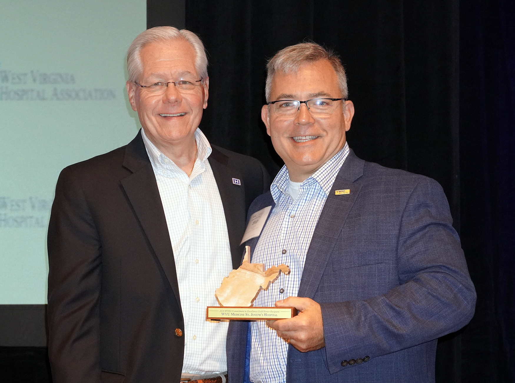(From left to right) Joe Letnaunchyn, president and CEO of the West Virginia Hospital Association, presents Skip Gjolberg, president of WVU Medicine St. Joseph's Hospital, with the Gold Honors Achievement Award.