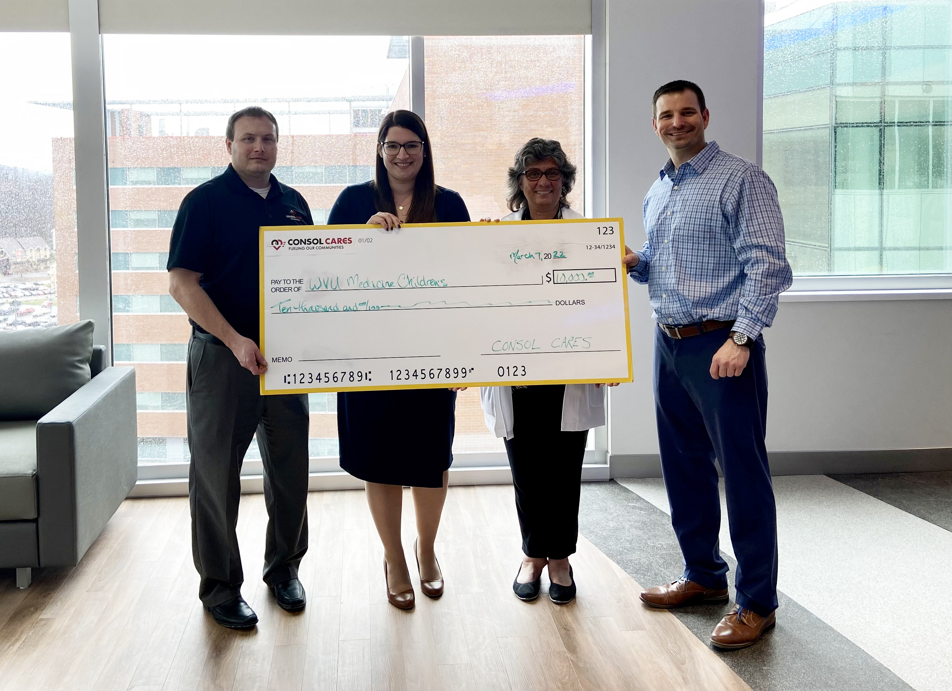 CONSOL Cares Foundation representatives Andrew Chumney (far left) and Christopher Rabbitt (far right) present their contribution to Rachel Blasko (center, left), assistant vice president for operations at WVU Medicine Children’s, and Mary Fanning (center, right), vice president of nursing clinical services and associate chief nursing officer for WVU Medicine Children’s.